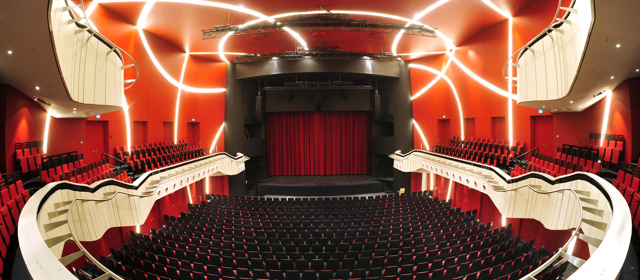 Theatersaal des Deutschen theaters in München mit leeren Stühlen und geschlossenem Vorhang
