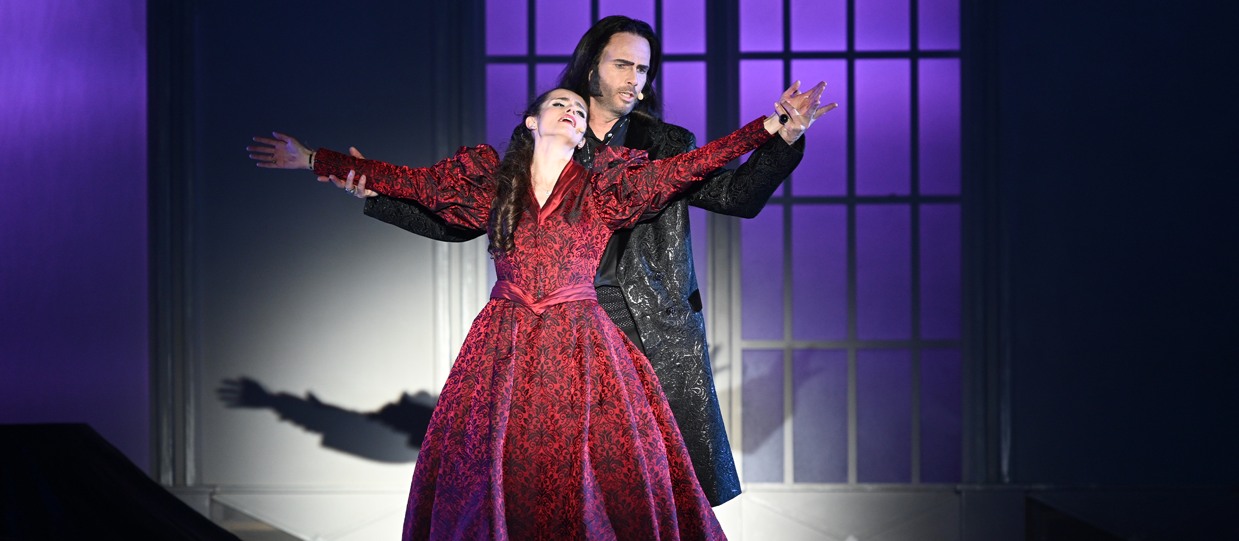 Thomas Borchert in der Rolle des Vampirs Dracula im gleichnamigen Musical verführt Mina, die in einem roten Kleid vor ihm steht